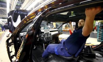 File photo of an employee of German car manufacturer Mercedes Benz working on the interior of a GLA model at their production line at the factory in Rastatt