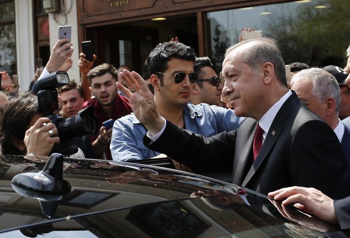 Turkish President Erdogan waves to supporters as he leaves Eyup Sultan mosque in Istanbul