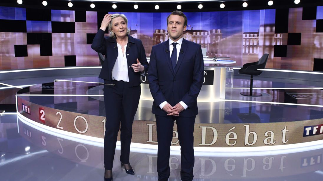 Candidates for the 2017 presidential election, Emmanuel Macron, head of the political movement En Marche !, or Onwards !, and Marine Le Pen, of the French National Front (FN) party, pose prior to the start of a debate in La Plaine-Sainte-Denis
